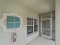 Screened-in patio entrance with a window and a fire extinguisher on the wall at 2204 L Pavia Blvd # 2204, Venice, FL 34292