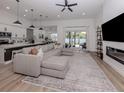 Spacious living room boasting a large sectional sofa, and seamless flow to the dining area and a view to the backyard at 2245 Pickard Ln, North Port, FL 34286