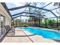 Inviting screened-in pool area with a sparkling blue pool, spa, and comfortable seating for outdoor relaxation at 2445 Apache St, Sarasota, FL 34231
