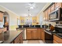 Well-lit kitchen with stainless steel appliances, granite countertops, and a breakfast nook at 24536 Buckingham Way, Port Charlotte, FL 33980