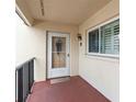 A welcoming condo entrance with a glass door, shutters, and a decorative wreath, offering curb appeal at 250 Santa Maria St # 314, Venice, FL 34285