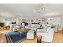 A spacious living room with hardwood floors, ceiling fans, and comfortable seating, perfect for relaxation at 250 Santa Maria St # 314, Venice, FL 34285