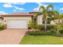 Lovely home with a two-car garage, mature landscaping, and a welcoming front entrance at 260 Soliera St, Nokomis, FL 34275