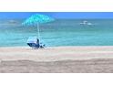 Secluded beach with beach chairs and umbrella for relaxing by the ocean at 333 The Esplanade N # 102, Venice, FL 34285