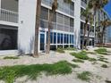 Beachfront condo with large windows, sliders and palm trees offering beautiful ocean views at 333 The Esplanade N # 102, Venice, FL 34285