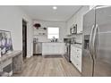 Modern kitchen with stainless steel appliances, white cabinets, and stylish countertops, creating a sleek design at 3340 Webber St, Sarasota, FL 34239