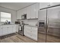 Modern kitchen with stainless steel appliances, white cabinets, and stylish countertops, creating a sleek design at 3340 Webber St, Sarasota, FL 34239