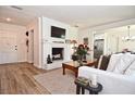 Charming living room with fireplace, modern decor, and an open view to the kitchen area at 3340 Webber St, Sarasota, FL 34239