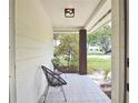 Covered porch with seating area, providing a relaxing outdoor space to enjoy the neighborhood views at 3340 Webber St, Sarasota, FL 34239