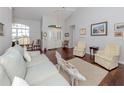 Inviting living room features hardwood floors, high ceilings, and an abundance of natural light at 337 Meadow Beauty Ct, Venice, FL 34293