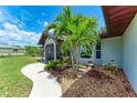 Landscaped front yard and a peaceful, inviting entryway of single-story home at 3376 Peace River Dr, Punta Gorda, FL 33983