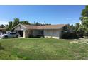 Single-story home with a well-kept lawn and a quaint, inviting appearance at 3661 Sterling Rd, Venice, FL 34293