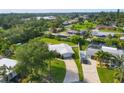 Beautiful home with a metal roof, a long driveway, mature trees, and a lush, green lawn at 458 Ceil Ct, Nokomis, FL 34275