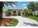 Inviting single-story home with lush landscaping, a circular driveway, and a double-door entry at 467 Sherbrooke Ct, Venice, FL 34293