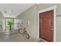 Hallway area showcasing a bicycle and the entrance to Unit 304 at 5459 Bentgrass Dr # 2-304, Sarasota, FL 34235