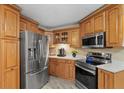 Well-equipped kitchen featuring stainless steel appliances, custom wood cabinets at 5828 Lincoln Rd, Venice, FL 34293