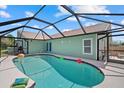 Enclosed screened in pool with floating ball toys, and an outdoor patio area at 5828 Lincoln Rd, Venice, FL 34293