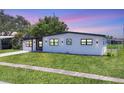 Well-maintained home with manicured lawn, modern design, and enhanced curb appeal on a gorgeous clear day at 6821 Marius Rd, North Port, FL 34287