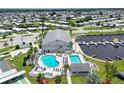 Aerial view of community clubhouse, pool, spa, boat docks, and manicured grounds at 738 Riverview Cir, North Port, FL 34287