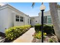 Inviting front entrance featuring a landscaped walkway and well-maintained exterior with tasteful planting at 751 Capri Isles Blvd # 108, Venice, FL 34292