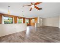 Spacious, wood-accented living room featuring hardwood floors, a ceiling fan, and recessed lighting at 844 Senda Plata # 27, Venice, FL 34293
