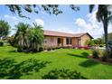 Beautifully landscaped front yard with vibrant flowers and lush green grass at 925 S Doral Ln, Venice, FL 34293
