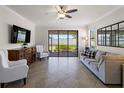Bright living room with a sliding glass door and neutral décor for a relaxing atmosphere at 9917 Haze Dr, Venice, FL 34292