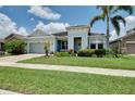 Delightful single-story home featuring verdant lawn, mature landscaping, and covered entry at 11560 Tapestry Ln, Venice, FL 34293