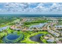Breathtaking aerial view of a scenic community with multiple lakes, golf courses, and lush greenery at 1210 Eagles Flight Way, North Port, FL 34287