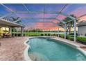 Inviting screened-in pool and spa with a spacious patio and views of the golf course at 1210 Eagles Flight Way, North Port, FL 34287