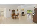 Bright living room with tile floors, fireplace, dining area, and sliding doors to the outdoors at 1315 Pine Needle Rd, Venice, FL 34285