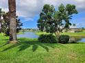 Beautiful view of the pond and manicured lawns at 1608 E Cypress Point Dr, Venice, FL 34293
