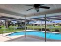 Screened-in pool with beautiful views of the neighborhood pond at 1608 E Cypress Point Dr, Venice, FL 34293