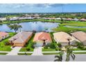 Aerial view of the home showing the tile roof, landscaping, lake view, and surrounding neighborhood at 1620 San Silvestro Dr, Venice, FL 34285