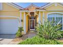 Inviting front entrance featuring mature landscaping and a decorative glass front door at 1620 San Silvestro Dr, Venice, FL 34285