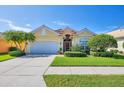 Charming home featuring manicured lawn, beautiful palms, tile roof and an attached two car garage at 1620 San Silvestro Dr, Venice, FL 34285