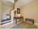 Inviting entryway with a staircase lift, stylish console table, bench seating, and neutral decor at 23527 Awabuki # 202, Venice, FL 34293