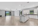 Bright, open kitchen with stainless steel appliances and an island with bar seating at 2487 Marton Oak Blvd, North Port, FL 34289