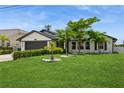 Inviting single-Gathering home showcasing a lush green lawn, mature trees, and a well-kept exterior at 26115 Rampart Blvd, Punta Gorda, FL 33983