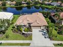 A beautiful home with a tile roof, a three-car garage and a lake view in a well manicured community at 2928 Seasons Blvd, Sarasota, FL 34240