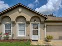 Close-up of front entrance with decorative arches, neutral exterior, and an attached garage at 3139 Point St, North Port, FL 34286