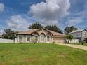 Charming single-story home featuring a well-manicured lawn and an attached two-car garage at 3139 Point St, North Port, FL 34286