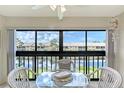 Bright dining area with lake view, creating a serene and inviting atmosphere at 330 Mission N Trl # F, Venice, FL 34285