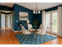 Cozy dining area featuring a glass table, modern chairs, and ample natural light at 3601 Point St, North Port, FL 34286