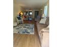 Inviting living room with wood floors, neutral walls, a comfortable couch, and ample seating at 3697 Lake Bayshore Dr # H-109, Bradenton, FL 34205