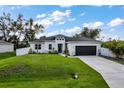 Beautiful single-story home with a well-maintained lawn and complemented by lush trees at 4033 Union Ln, North Port, FL 34288