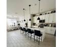 Modern kitchen with white cabinets, quartz countertops, and stainless steel appliances at 4033 Union Ln, North Port, FL 34288
