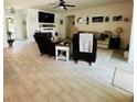 Open-concept living room with tile floors, comfortable seating, and plenty of natural light at 4033 Union Ln, North Port, FL 34288