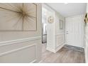 An entry hallway featuring wood flooring, wainscoting, and decor at 408 Cerromar S Cir # 331, Venice, FL 34293