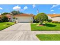 Charming single-story home with a well-manicured lawn, mature landscaping, and a two-car garage at 4114 Murfield E Dr, Bradenton, FL 34203
